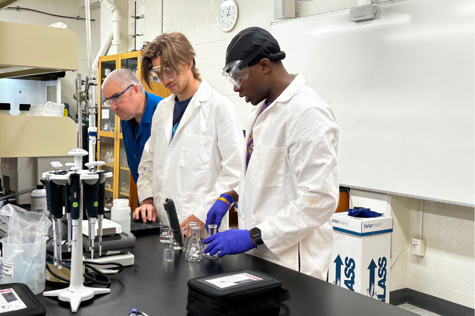 Students and faculty in the lab testing samples