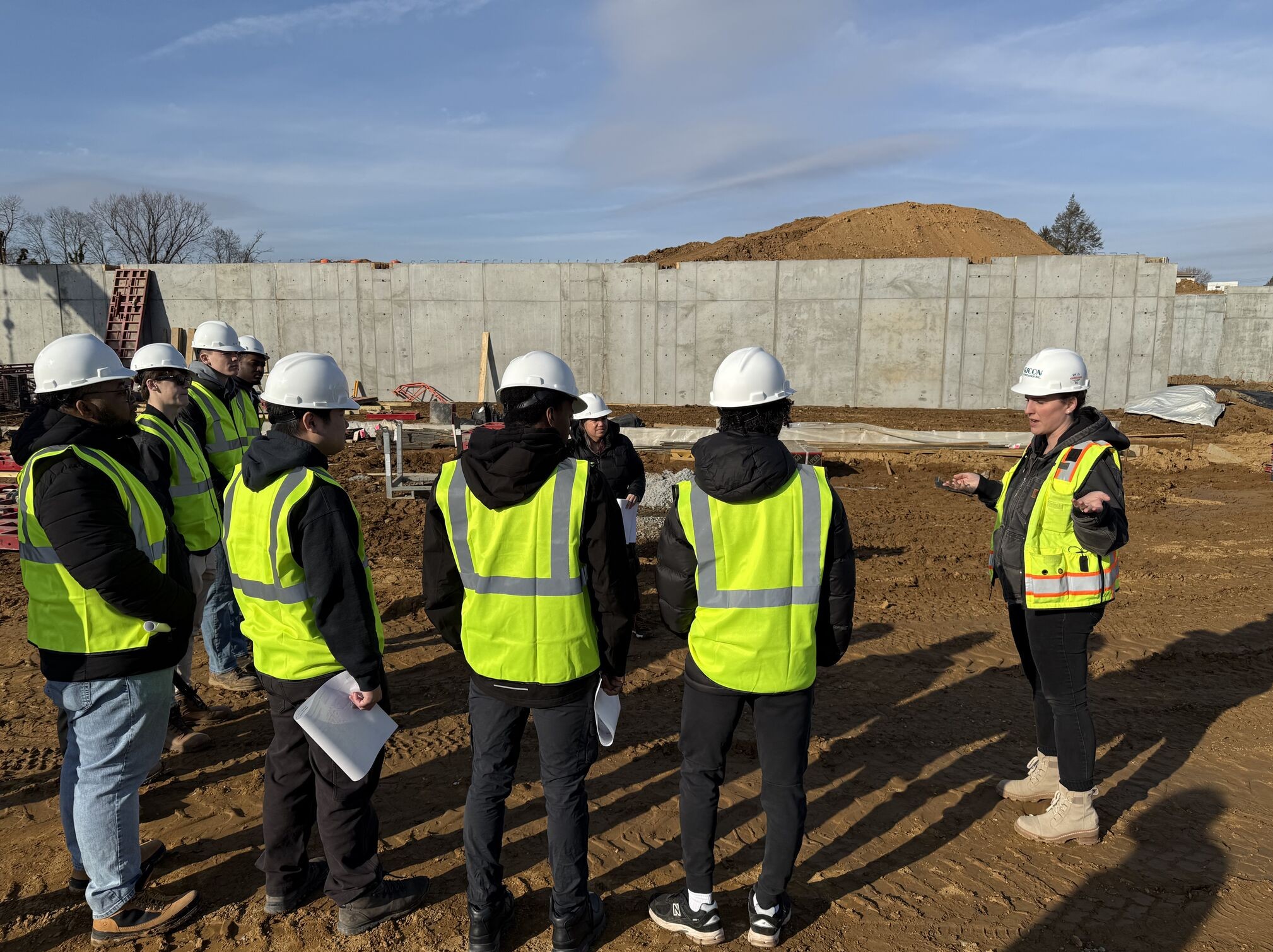 Students wear yellow vests and hard hats.