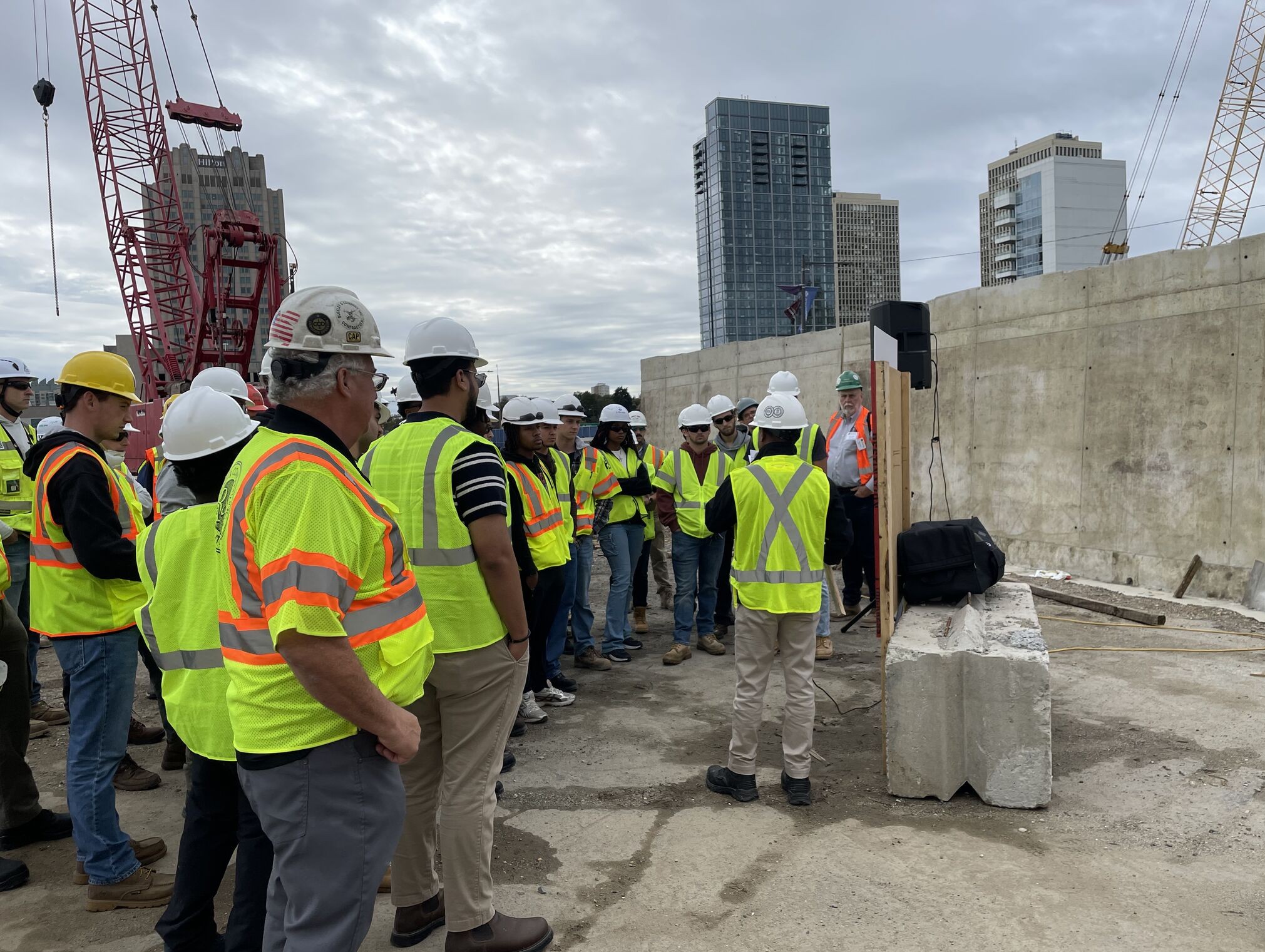 Students wear yellow vests and hard hats.
