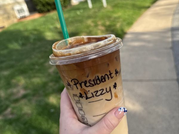 A Starbucks cup reads "President Lizzy"