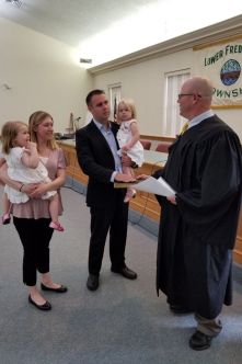 Chuck Liedike is sworn in to township manager role beside his wife and children