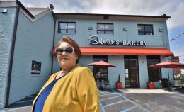 Silvia Paulino poses in front of her bakery, Silvia's Bakery