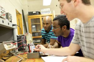Electrical engineering master's students work together on a project.