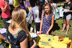 students chat at club table at involvement fair