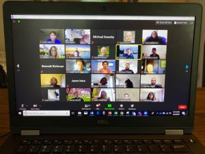 Laptop shows students and faculty on Zoom discussing summer research