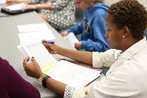 Adult student in class reading papers