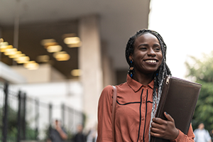 Business professional with padfolio in a city setting