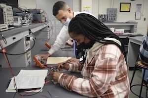 Engineering faculty member helping out Widener student who is working towards a master's in electrical engineering.