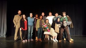 The Lone Brick cast poses on stage.