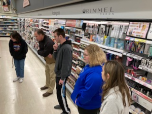 Students looking at shaving products at a big-box store