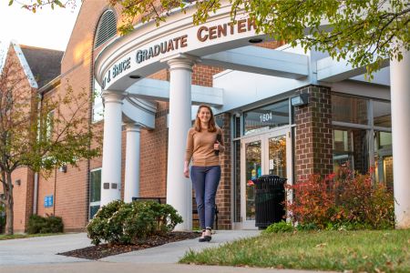 Grad student walking in front of Bruce Hall 960x640 Grad student walking in front of Bruce Hall