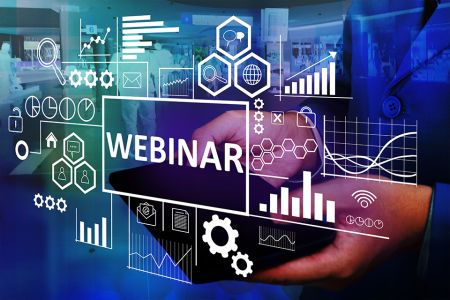 Graphic image of the word webinar on glass over a picture of hands holding a laptop