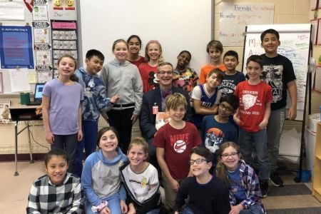 Joseph Meloche Superintendent 960 x 640 Superintendent Joseph Meloche sits in a classroom with children