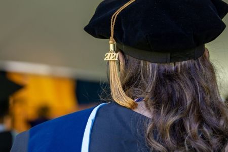 Back of graduate's head shows cap and 2021 tassel