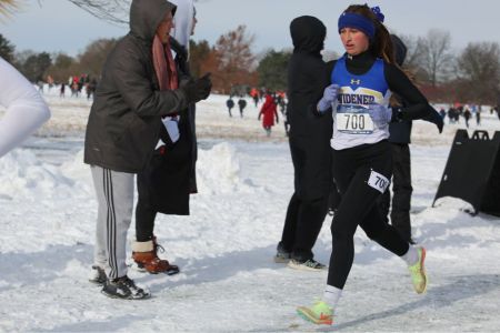 Gabby Nye runs during the NCAA cross country championship in the snow in Michigan.