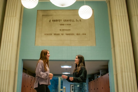 Students Emma Lavin and Saleeth Ulloa Lasso talking in hallway of Kapelski Learning Center