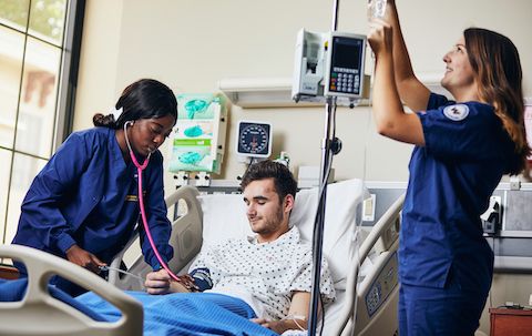 Nursing Simulation Lab with nursing students and student patient