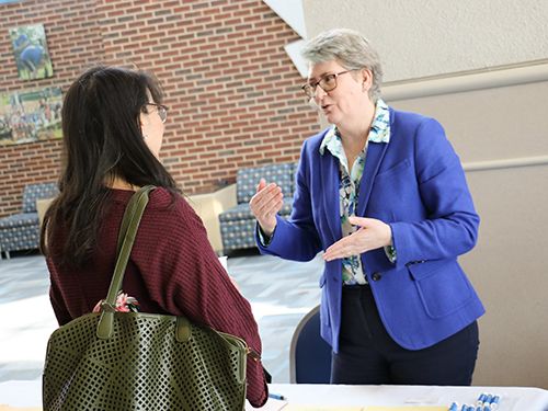 Grad Adult Student Open House 500x375 student talks with faculty at open house