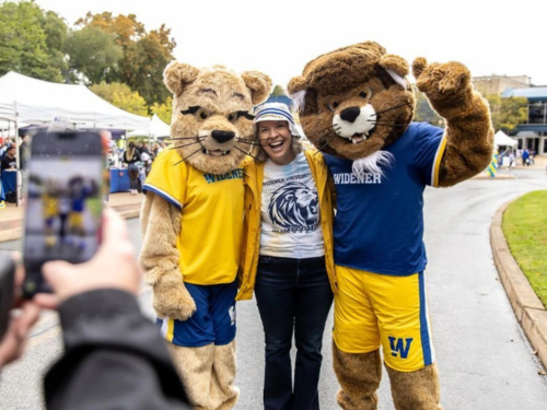 President Stacey Robertson poses for a photo with the university mascots, Chester and Melrose