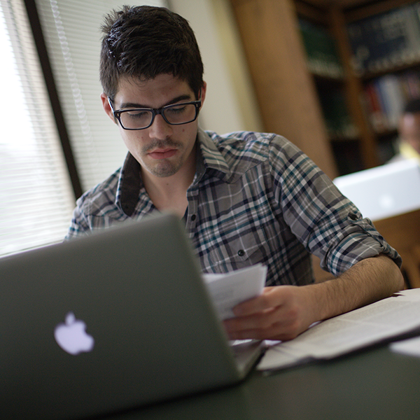 Student on laptop in library 600x600 Student on laptop in library